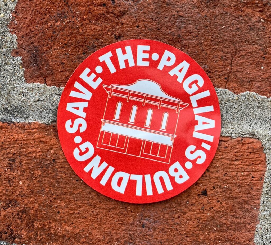 Save The Pagliai's Building - Sticker on the Holub Apartments Bricks in Iowa City